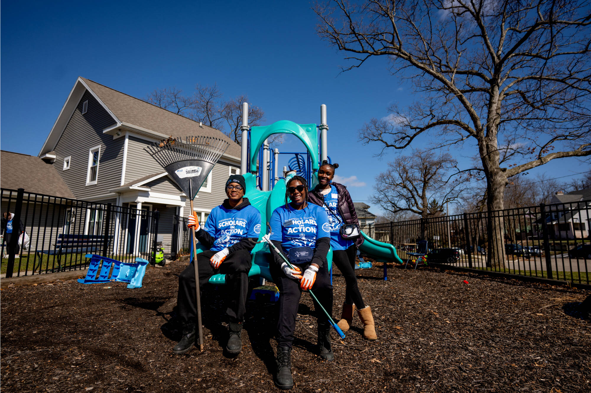 student holding rakes on slide